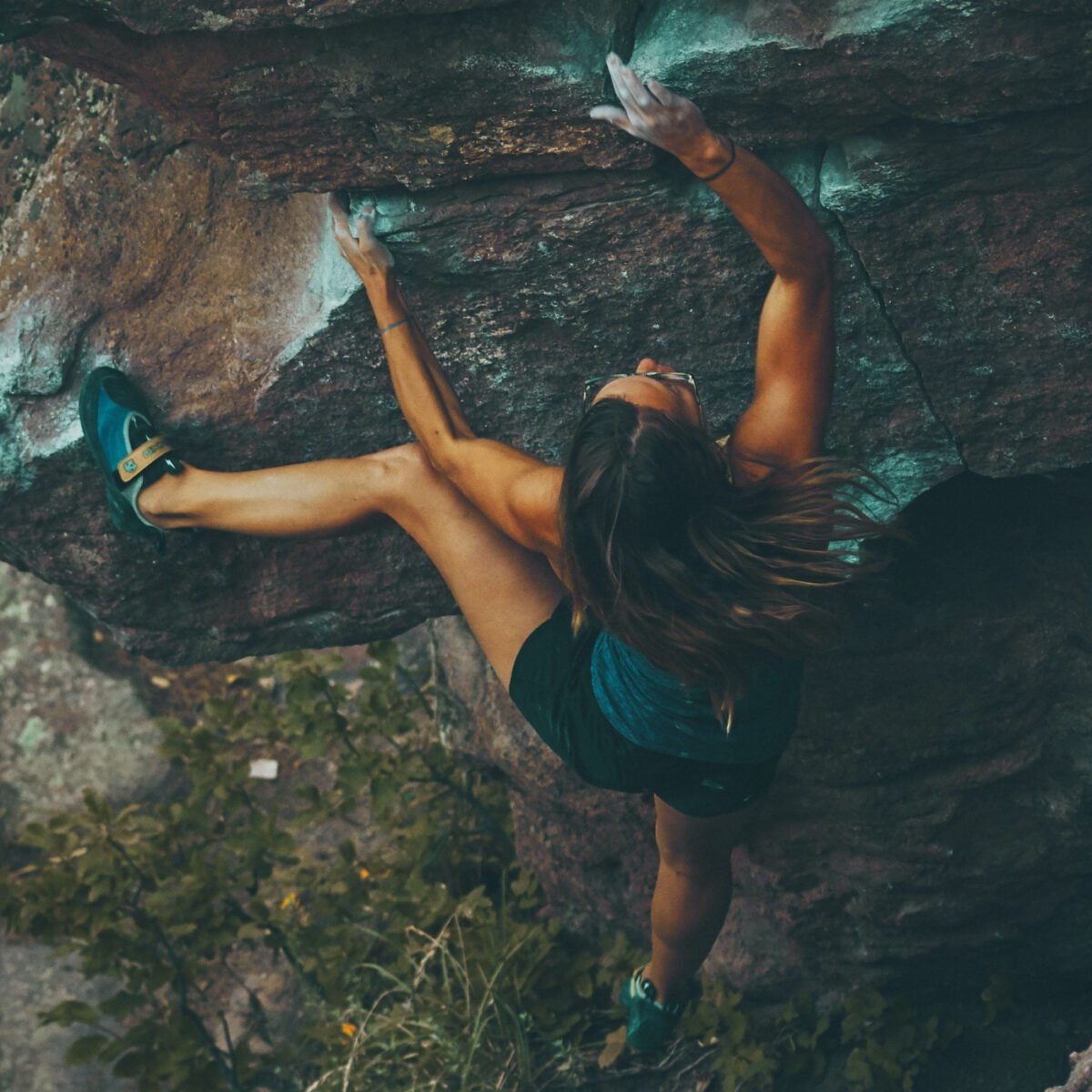 A person confidently free climbing a steep wall.